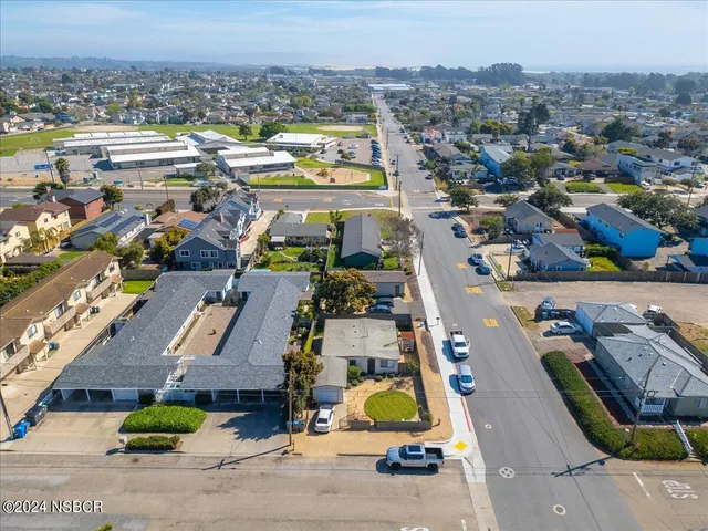 an aerial view of residential houses with outdoor space