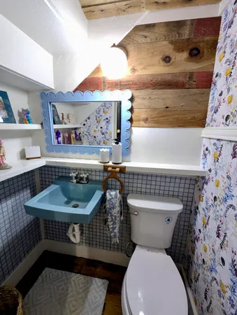 a bathroom with a sink toilet and a mirror