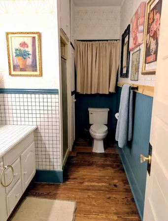 a bathroom with a toilet and a shower curtain