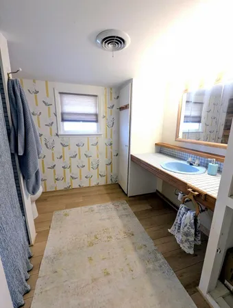 a spacious bedroom with a bed and a window