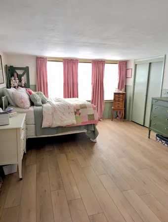 a bed room with a bed and a chair