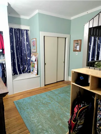 a view of a living room with clothes and