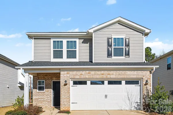 a front view of a house with a garage