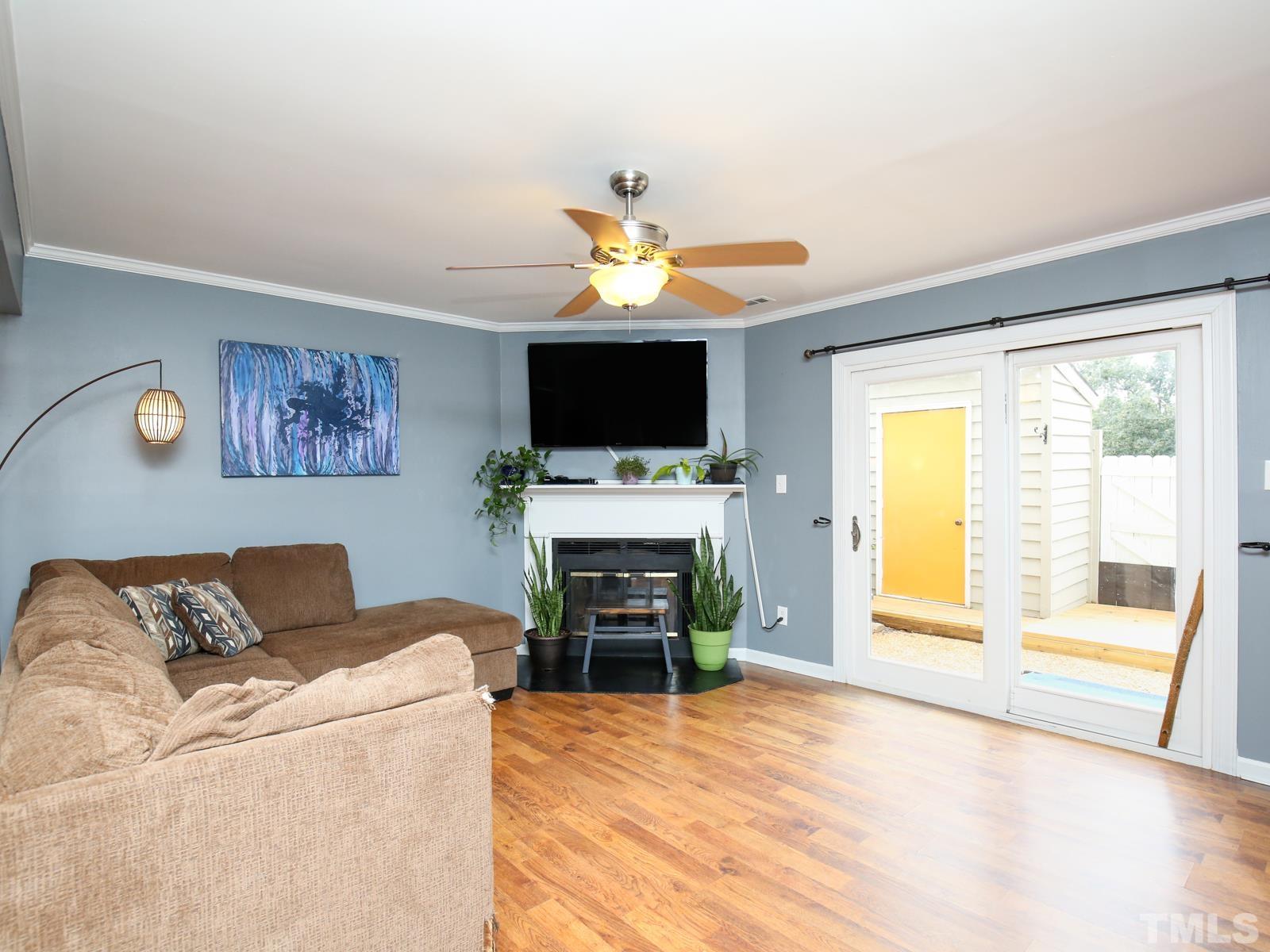 5423 Pine Top Circle Raleigh, NC 27612 - Photo 2 of 30 a living room with furniture a fireplace and a flat screen tv