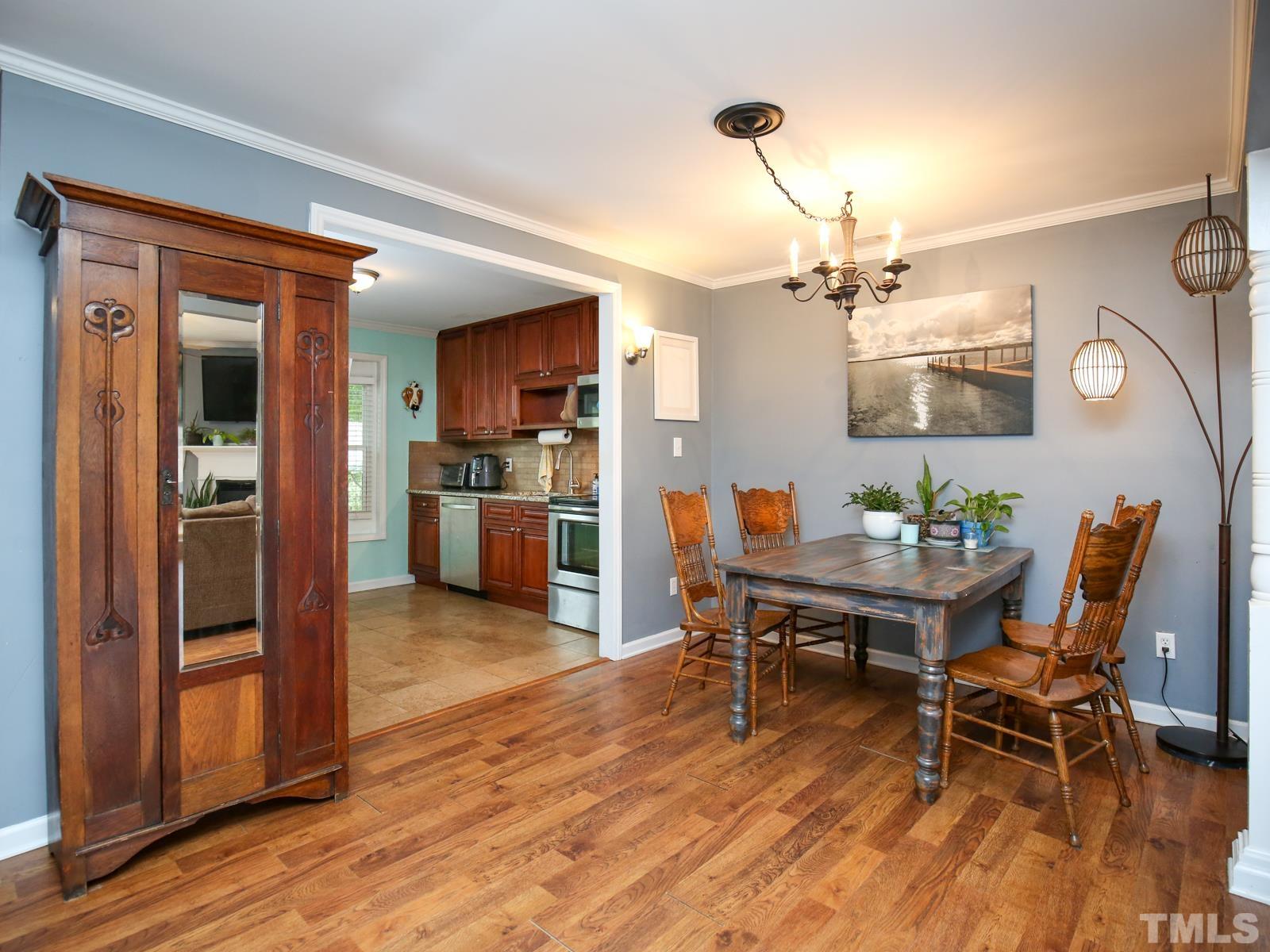 5423 Pine Top Circle Raleigh, NC 27612 - Photo 11 of 30 a view of a dining room with furniture and wooden floor