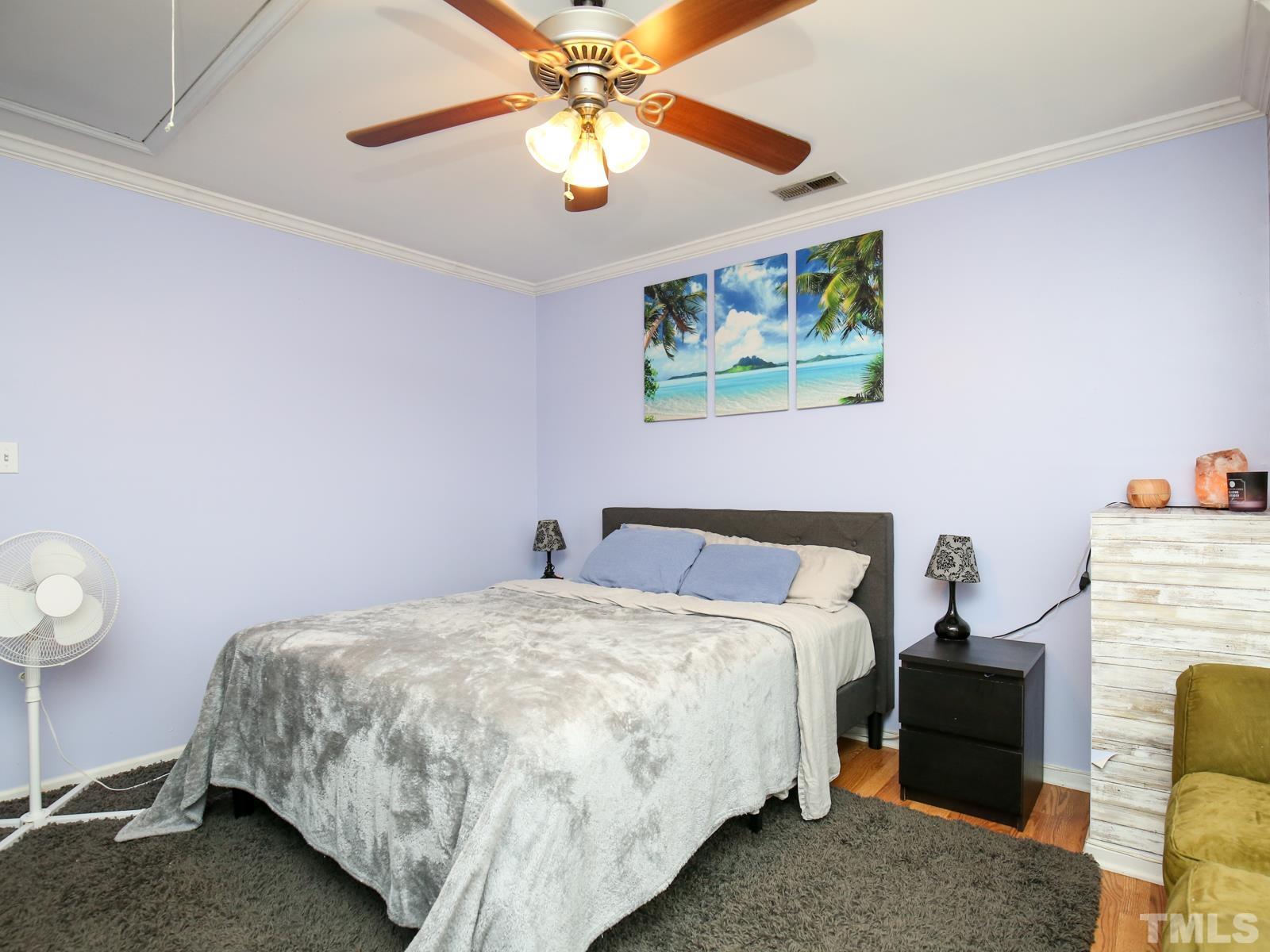 5423 Pine Top Circle Raleigh, NC 27612 - Photo 15 of 30 a bedroom with a bed and a chandelier