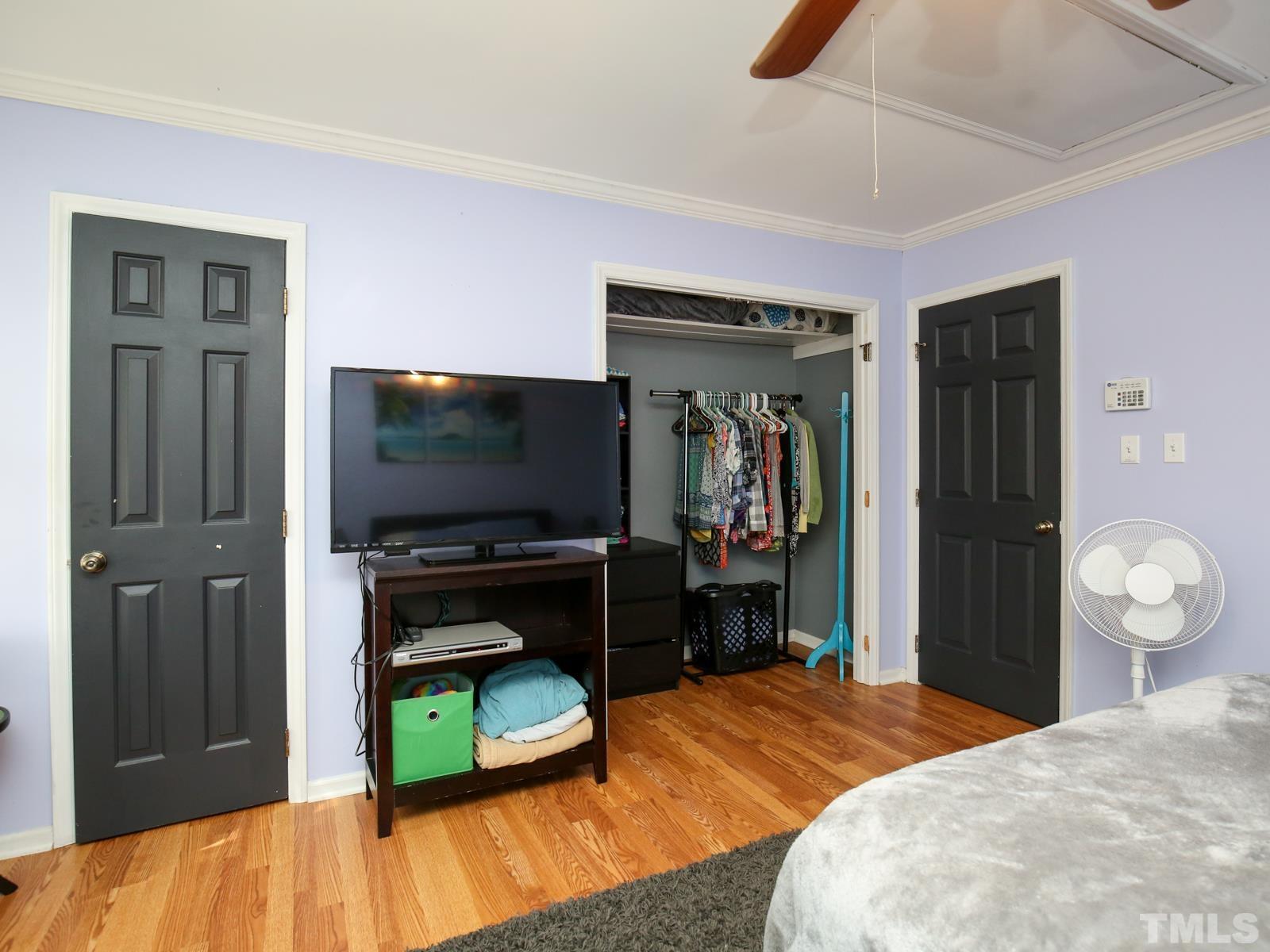 5423 Pine Top Circle Raleigh, NC 27612 - Photo 16 of 30 a bedroom with a bed and a flat screen tv