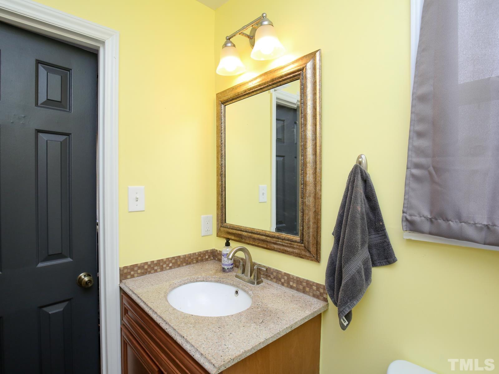 5423 Pine Top Circle Raleigh, NC 27612 - Photo 19 of 30 a bathroom with a sink vanity and a mirror