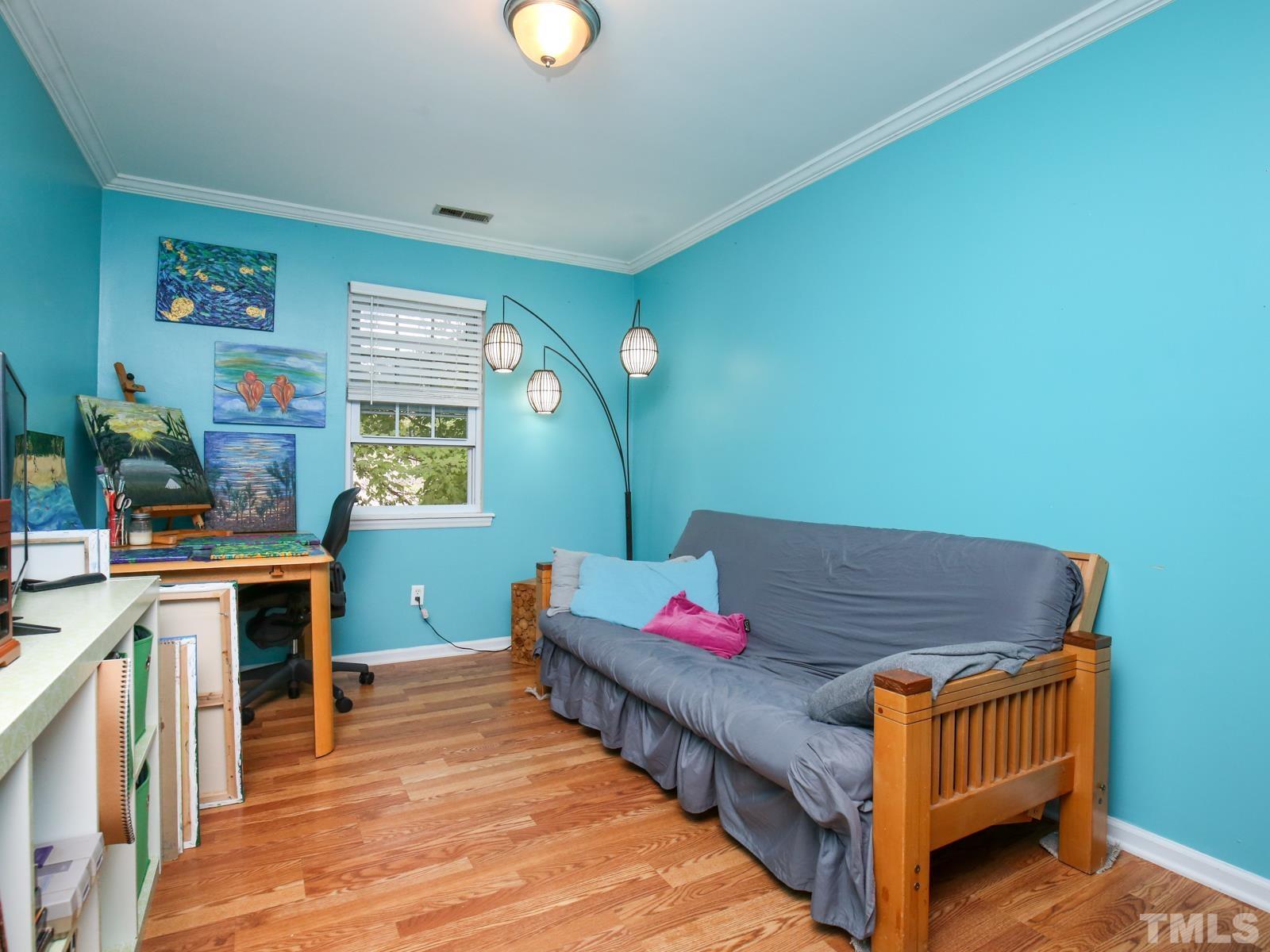 5423 Pine Top Circle Raleigh, NC 27612 - Photo 20 of 30 a bedroom with furniture and a wooden floor