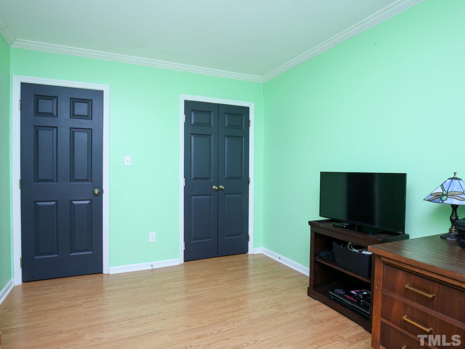 5423 Pine Top Circle Raleigh, NC 27612 - Photo 23 of 30 a room with closet and flat screen tv