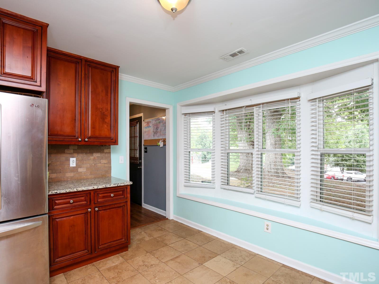 5423 Pine Top Circle Raleigh, NC 27612 - Photo 8 of 30 a kitchen with stainless steel appliances granite countertop a refrigerator and a sink