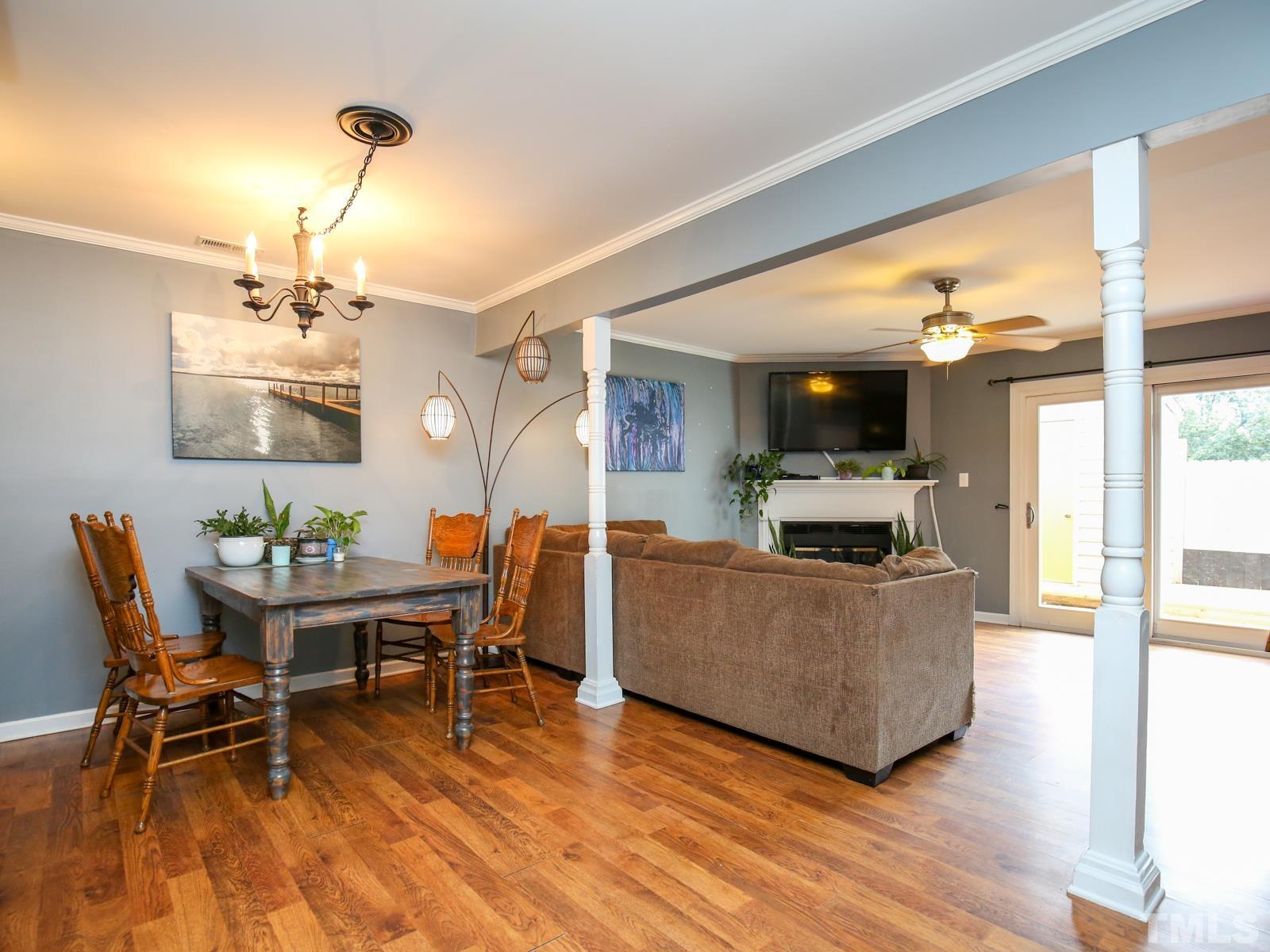 5423 Pine Top Circle Raleigh, NC 27612 - Photo 10 of 30 a living room with furniture a dining table and chairs with wooden floor