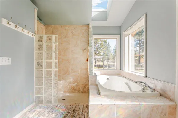 a bathroom with a bathtub and a shower