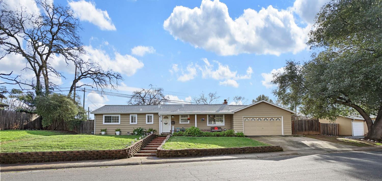 8814 Mohawk Way Fair Oaks, CA 95628 - Photo 1 of 34 a view of a big house with a big yard and large trees