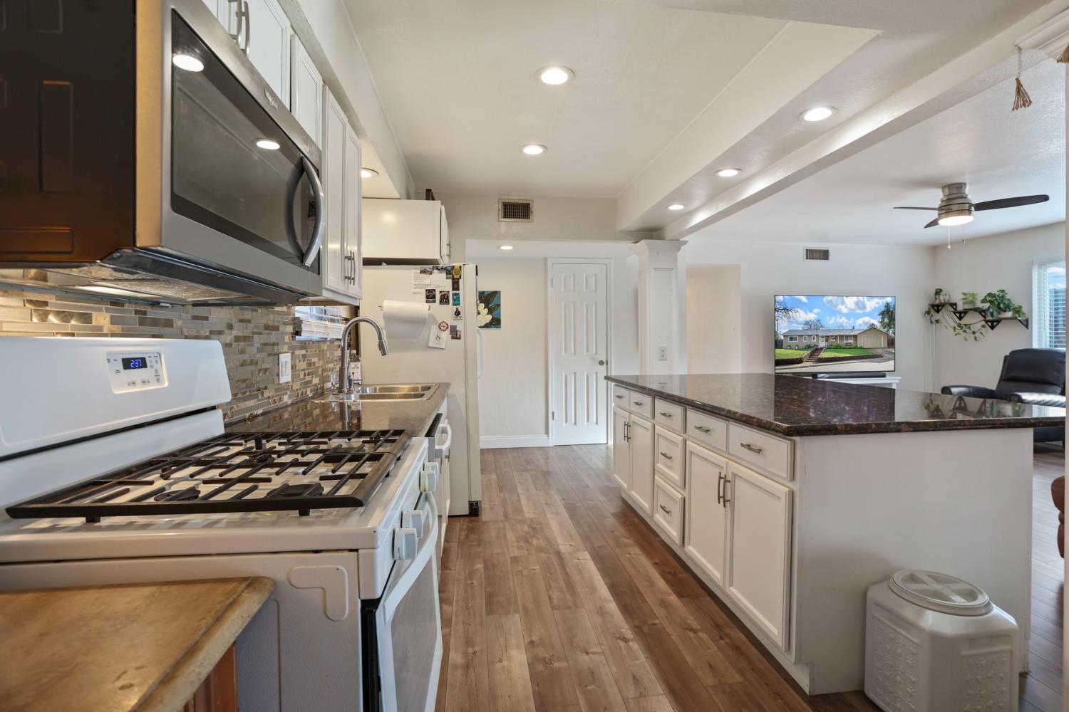 8814 Mohawk Way Fair Oaks, CA 95628 - Photo 12 of 34 a kitchen with stove a sink and refrigerator
