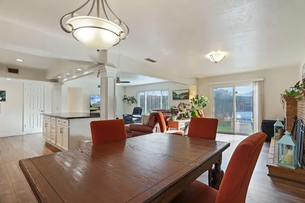 a view of a dining room with furniture and wooden floor