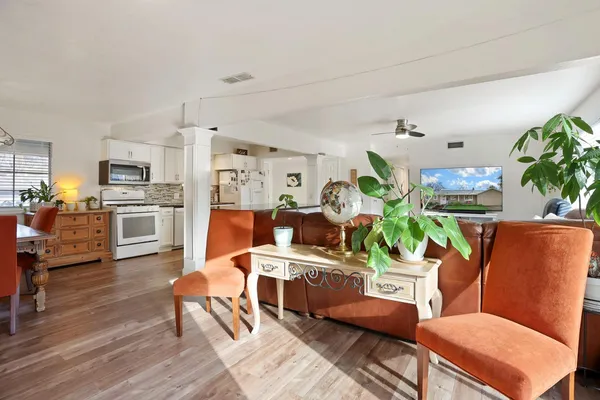 a living room with furniture kitchen view and a dining table