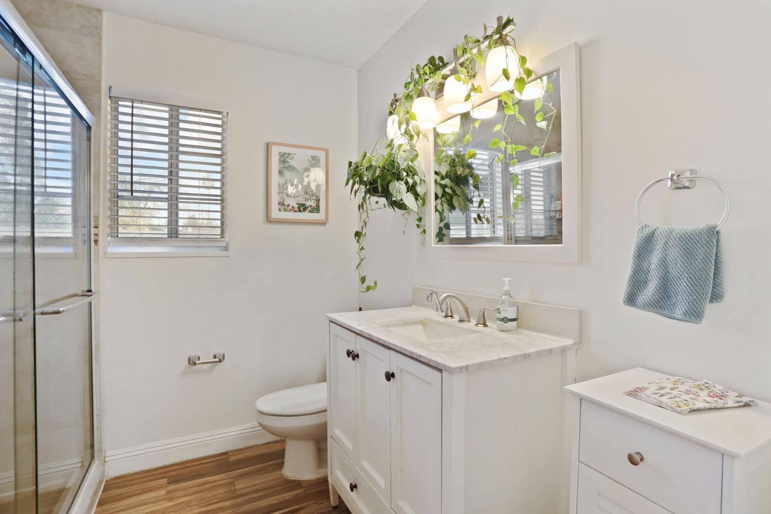8814 Mohawk Way Fair Oaks, CA 95628 - Photo 18 of 34 a bathroom with a granite countertop toilet a sink a large mirror and a window