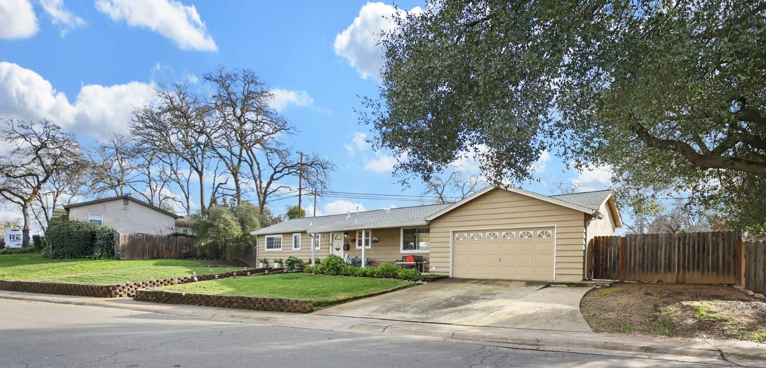 8814 Mohawk Way Fair Oaks, CA 95628 - Photo 2 of 34 a front view of a house with a yard and garage