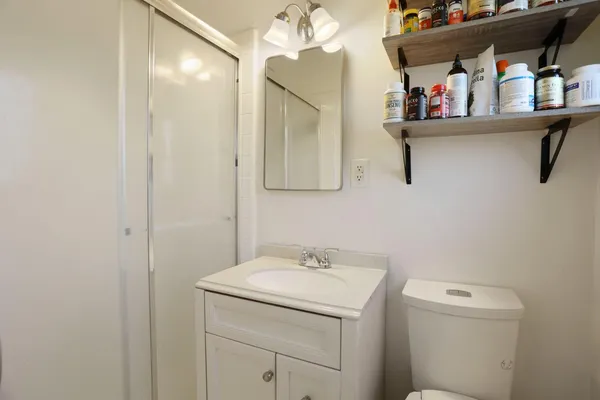 a bathroom with a sink vanity and mirror