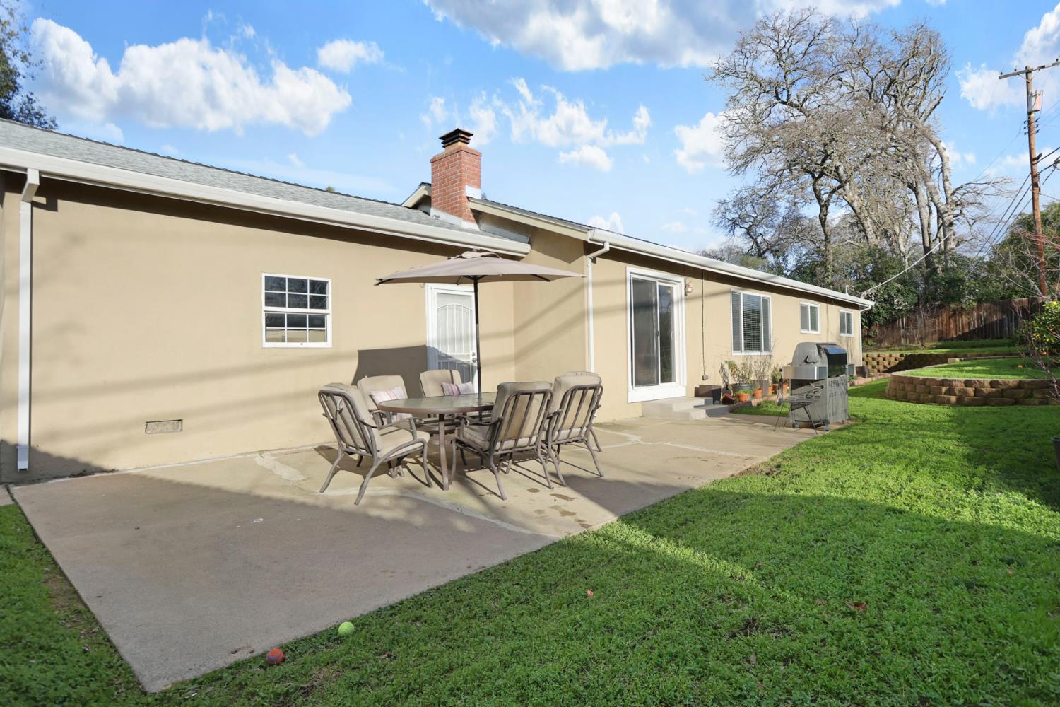 8814 Mohawk Way Fair Oaks, CA 95628 - Photo 29 of 34 a view of a patio with table and chairs with a yard and plants