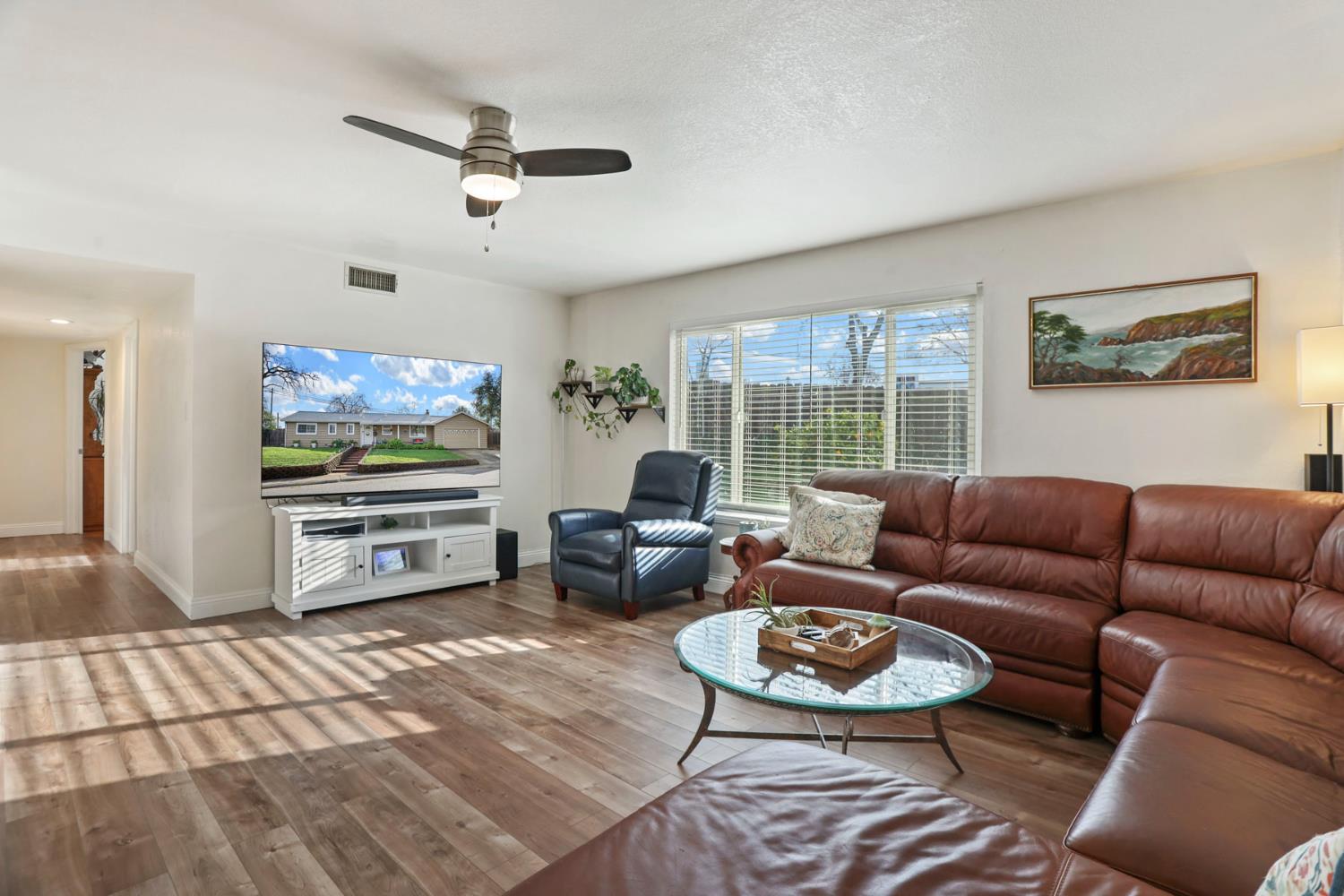 8814 Mohawk Way Fair Oaks, CA 95628 - Photo 5 of 34 a living room with furniture a large window and a flat screen tv