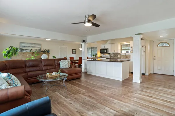 a living room with furniture and kitchen view