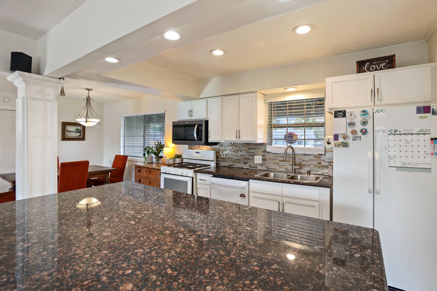 8814 Mohawk Way Fair Oaks, CA 95628 - Photo 9 of 34 a kitchen with stainless steel appliances a stove a sink cabinets and a refrigerator