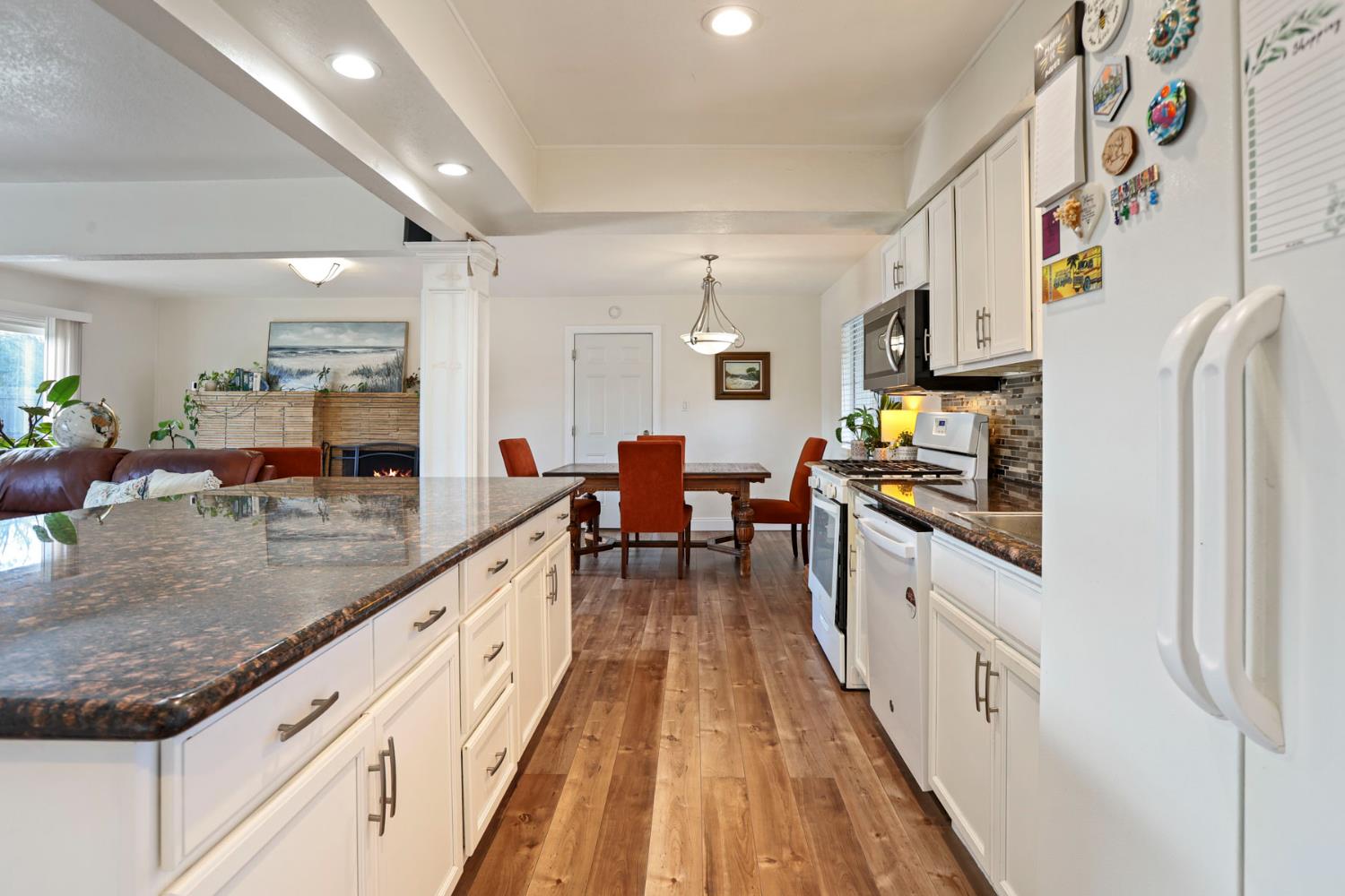 8814 Mohawk Way Fair Oaks, CA 95628 - Photo 10 of 34 a kitchen with granite countertop lots of counter top space and wooden floor