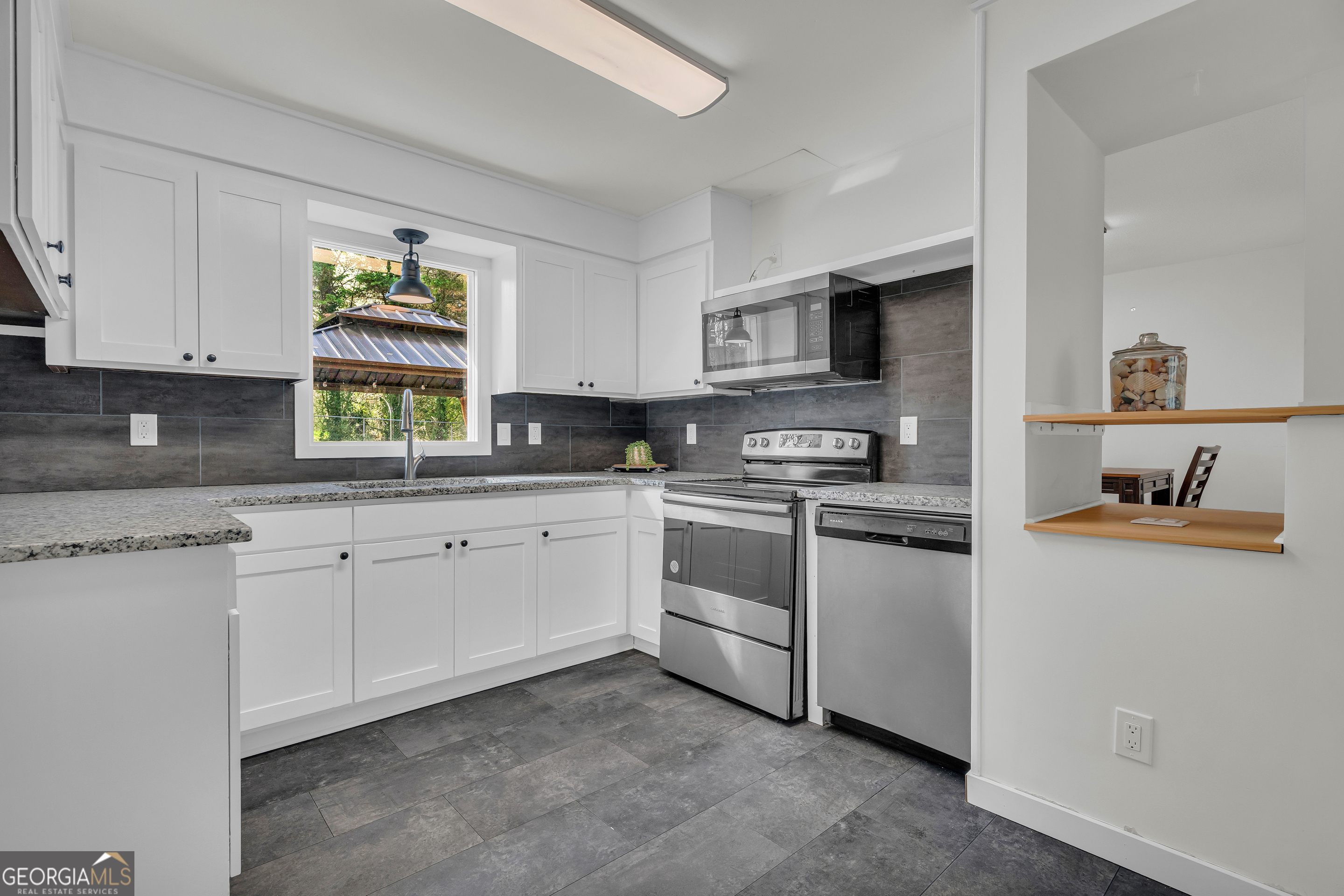 156 White Pine Road Toccoa, GA 30577 - Photo 15 of 57 a kitchen with granite countertop white cabinets and white appliances