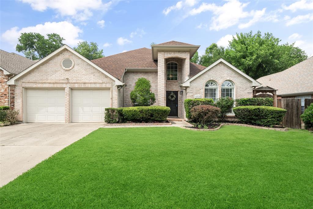 a front view of a house with a garden and plants