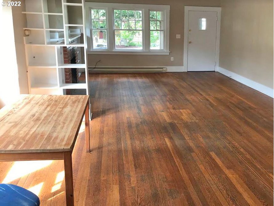 1877 Harris Street Eugene, OR 97403 - Photo 2 of 7 an empty room with wooden floor and windows