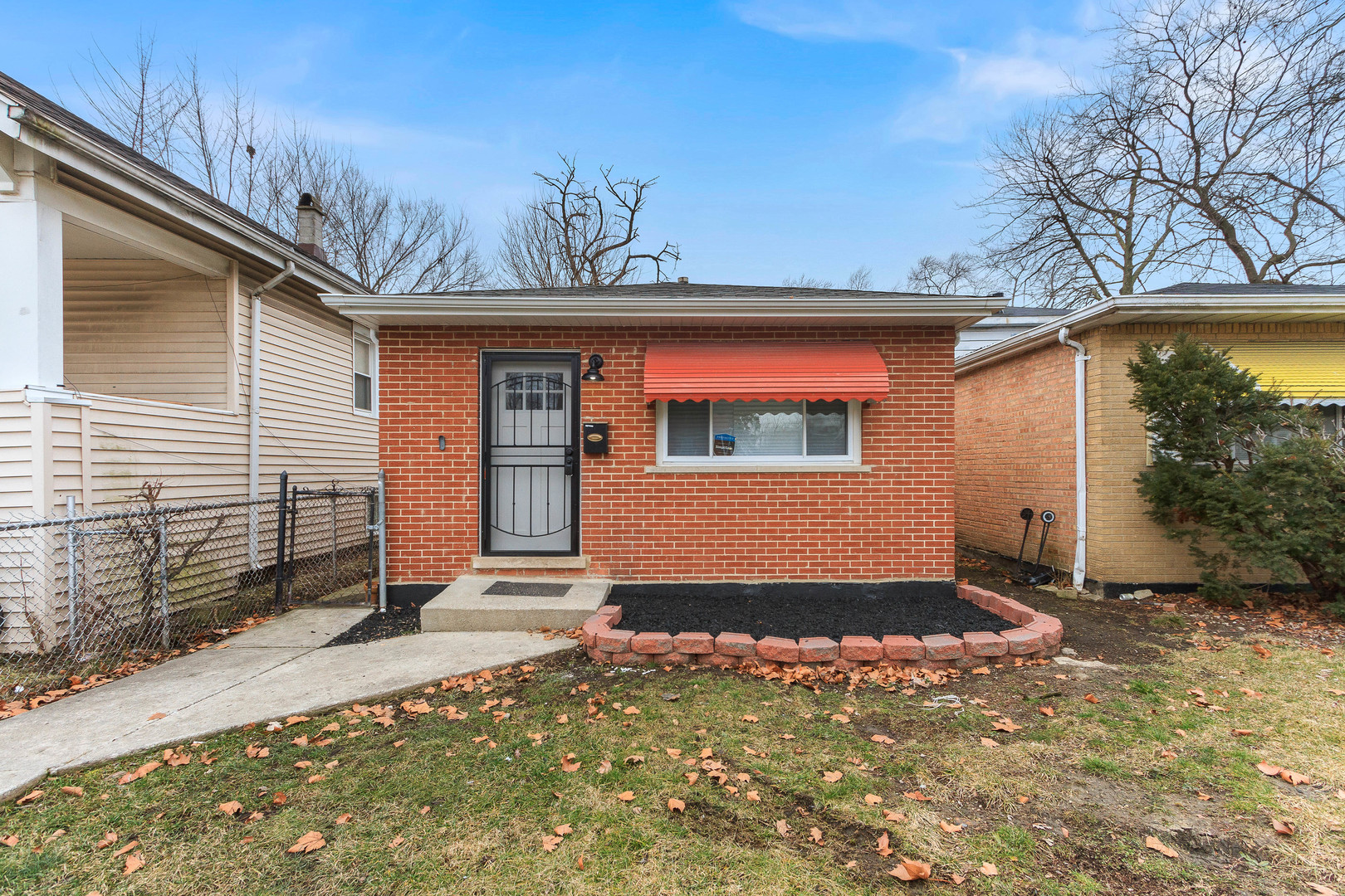 10002 South Normal Avenue Chicago, IL 60628 - Photo 1 of 29 a view of a house with a snow on the wall