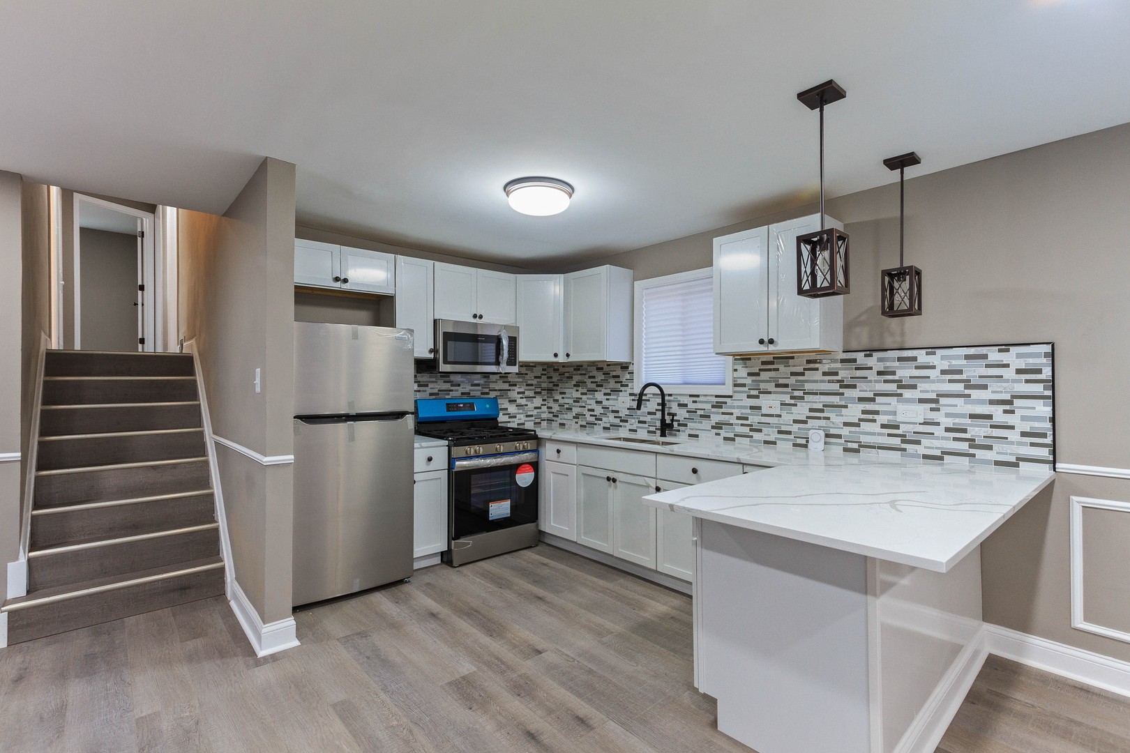 10002 South Normal Avenue Chicago, IL 60628 - Photo 14 of 29 a kitchen with granite countertop a refrigerator and a stove top oven