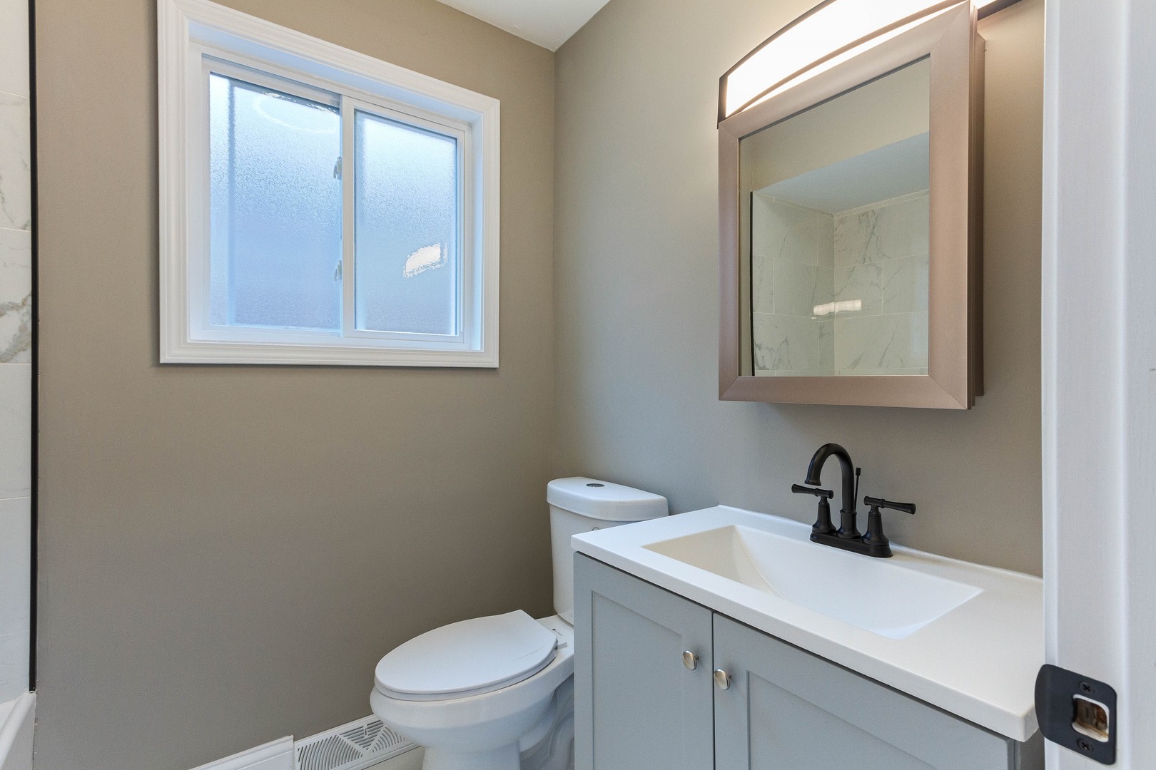 10002 South Normal Avenue Chicago, IL 60628 - Photo 16 of 29 a bathroom with a toilet sink and mirror