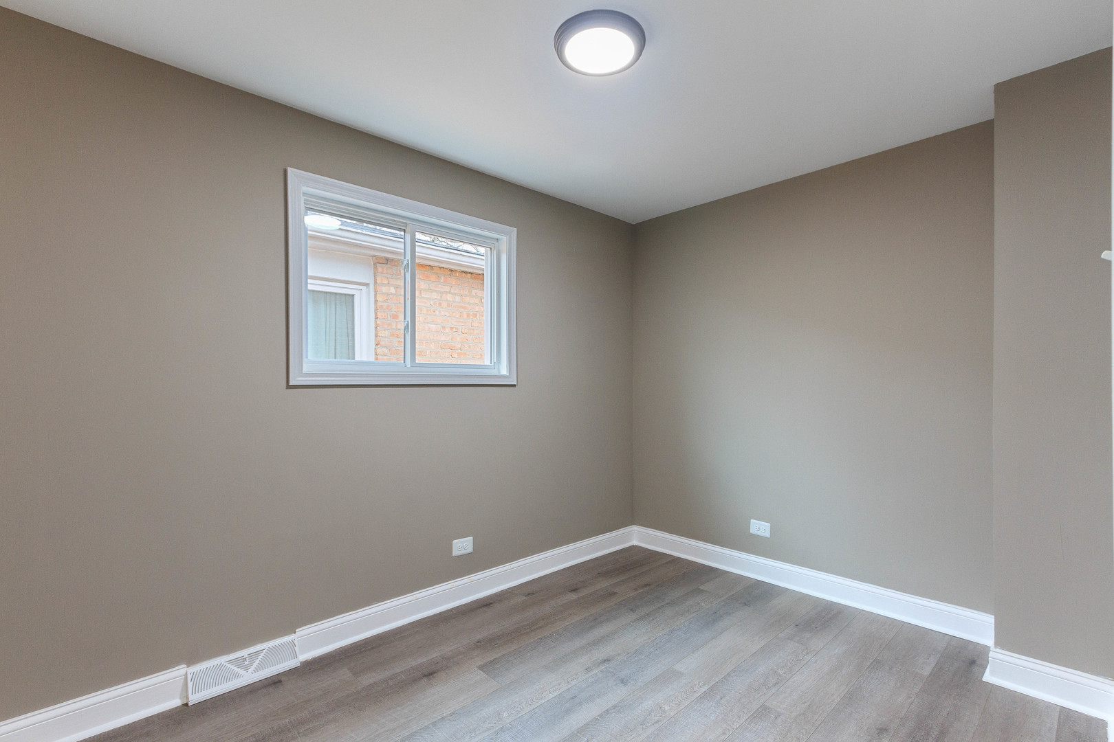 10002 South Normal Avenue Chicago, IL 60628 - Photo 17 of 29 an empty room with wooden floor and windows