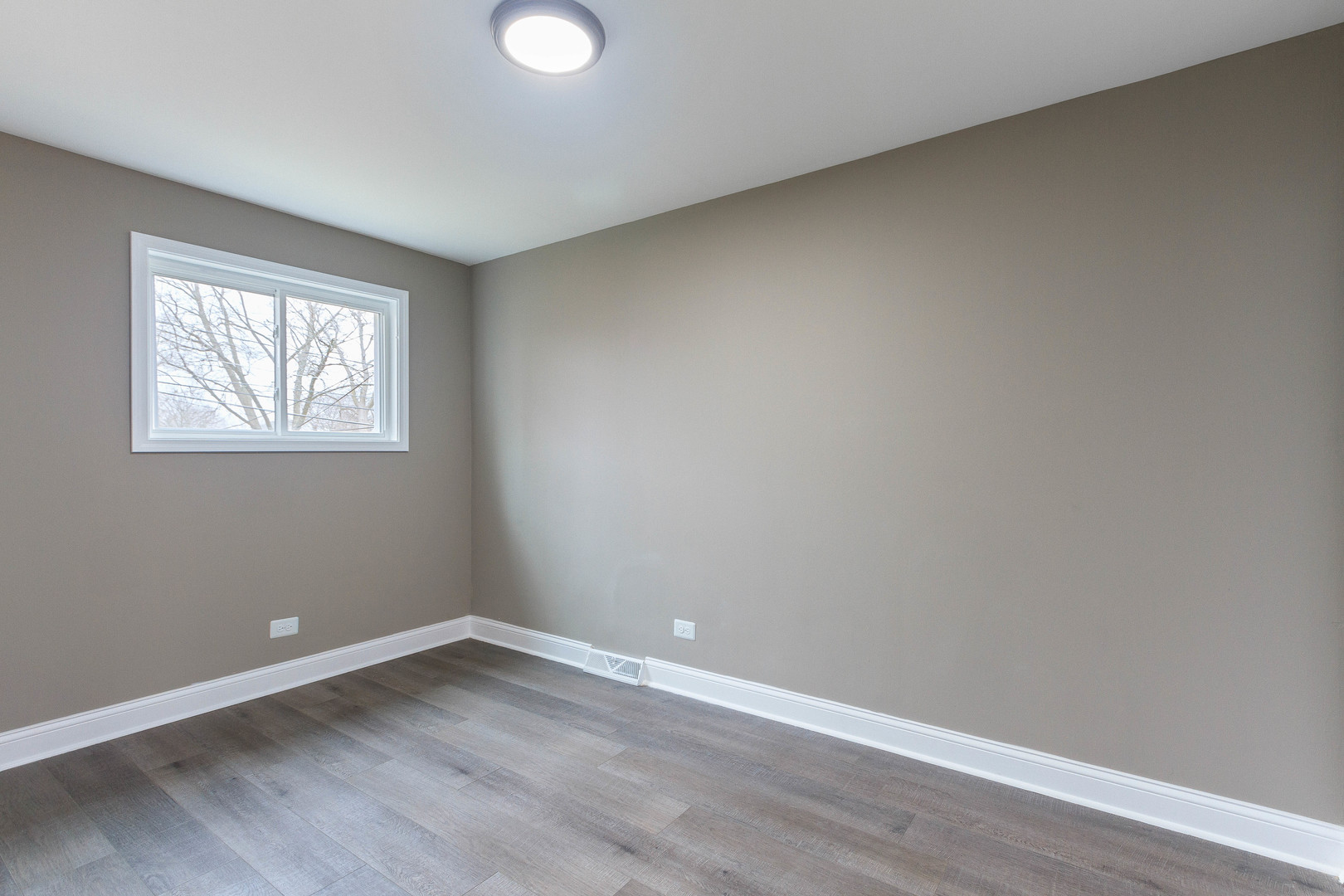 10002 South Normal Avenue Chicago, IL 60628 - Photo 19 of 29 an empty room with wooden floor and windows