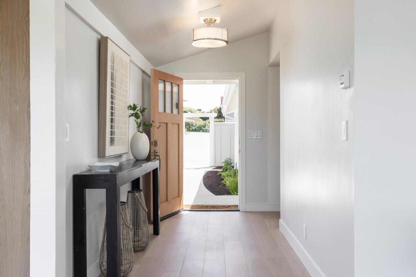 2765 Ribera Road Carmel, CA 93923 - Photo 11 of 37 a view of a hallway to a livingroom with furniture wooden floor and a window