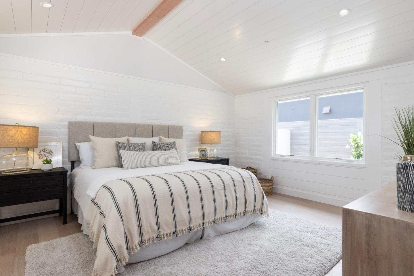 2765 Ribera Road Carmel, CA 93923 - Photo 14 of 37 a bedroom with a bed and a lamp on dresser