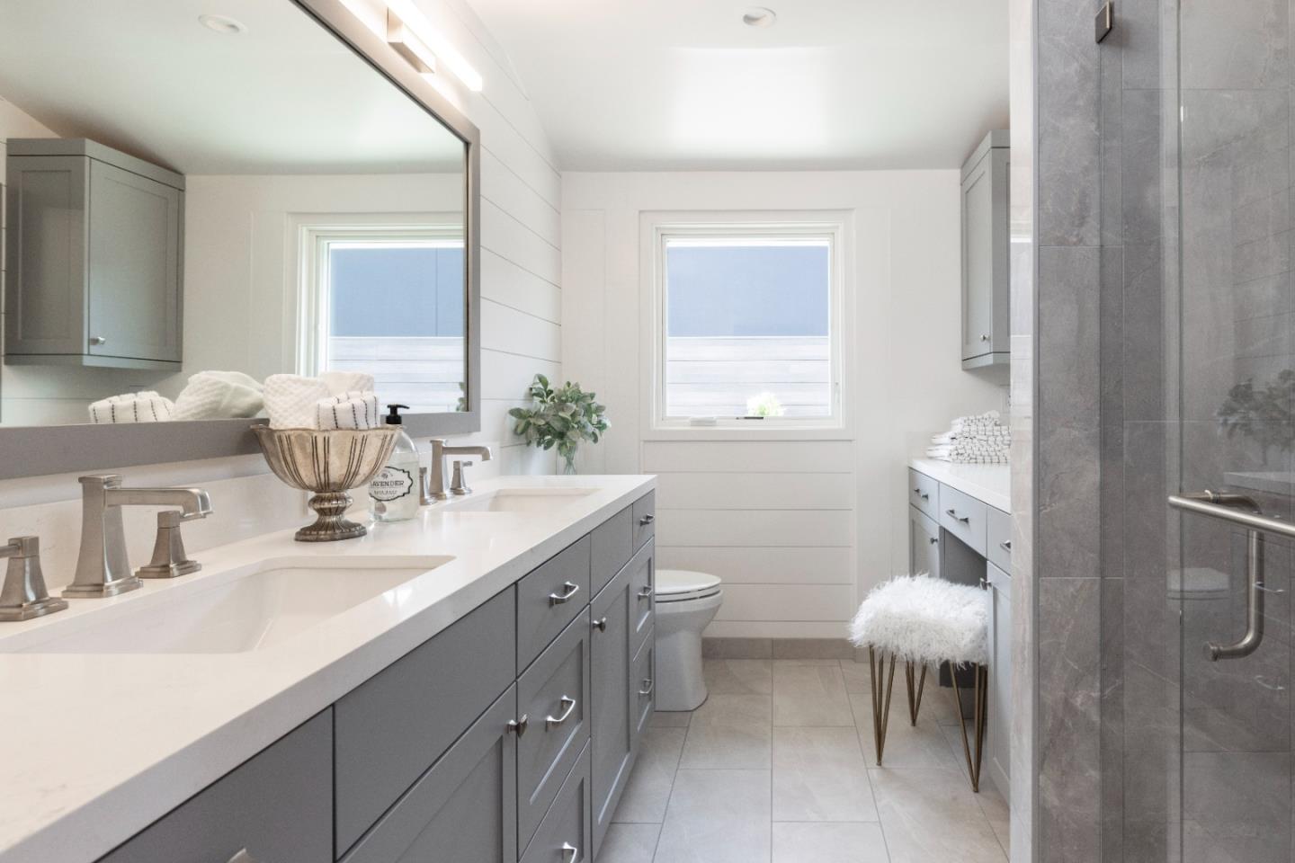 2765 Ribera Road Carmel, CA 93923 - Photo 16 of 37 a bathroom with a double vanity sink toilet and a mirror