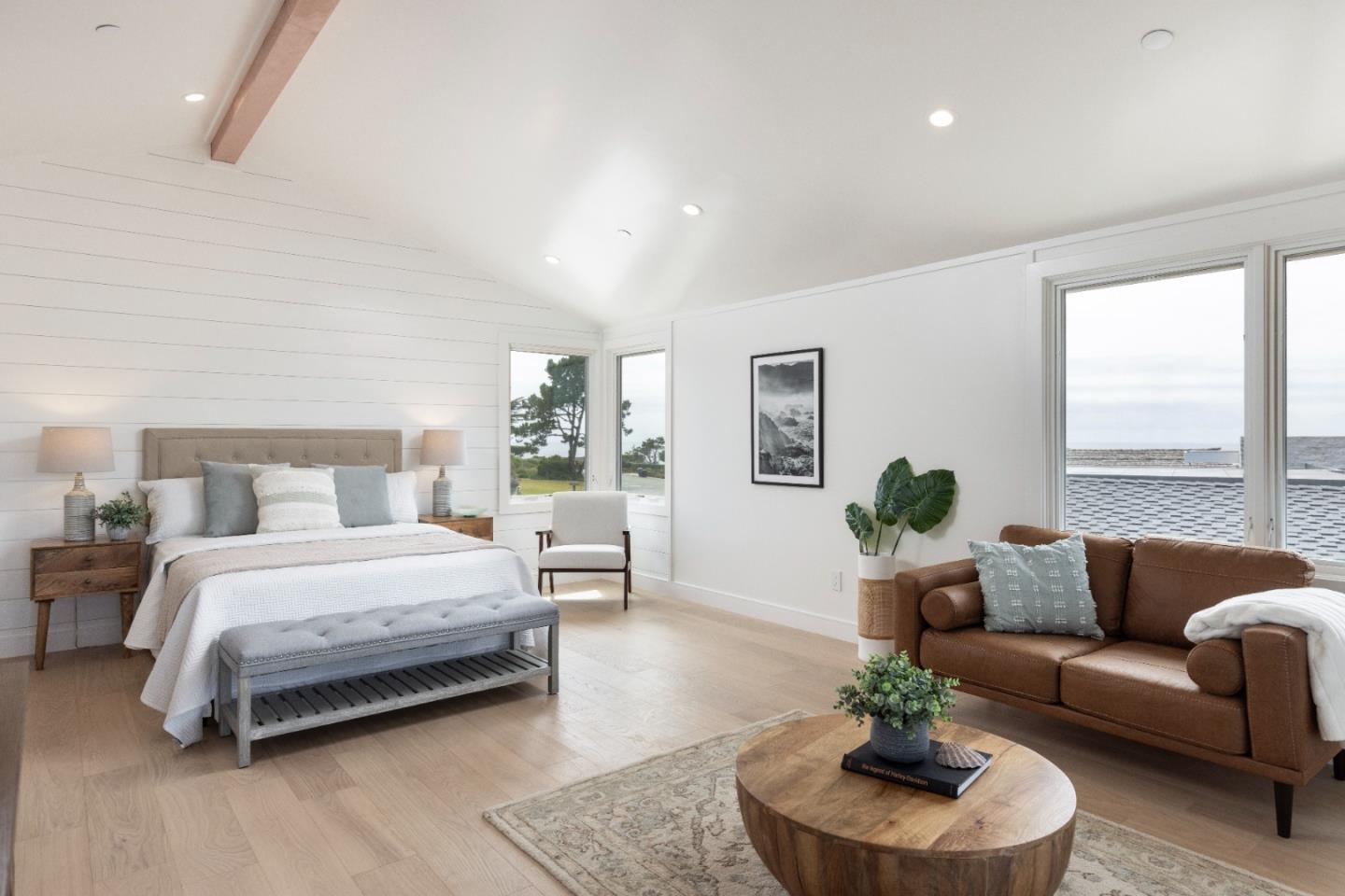 2765 Ribera Road Carmel, CA 93923 - Photo 19 of 37 a spacious bedroom with a bed a couch and a potted plant