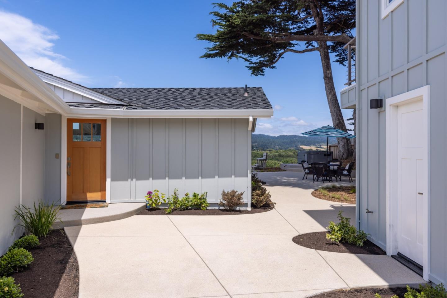 2765 Ribera Road Carmel, CA 93923 - Photo 34 of 37 a front view of a house with a yard and potted plants