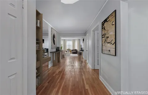 a view of a hallway view with wooden floor and living room