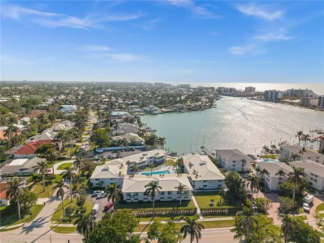 an aerial view of residential building with ocean view
