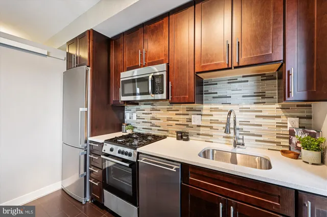 a kitchen with a sink stove and microwave