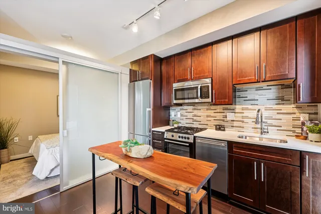 a kitchen with stainless steel appliances granite countertop a stove a sink dishwasher and microwave