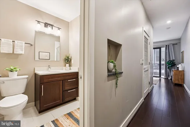 a spacious bathroom with a toilet sink and mirror