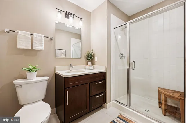 a bathroom with a toilet a sink and a mirror