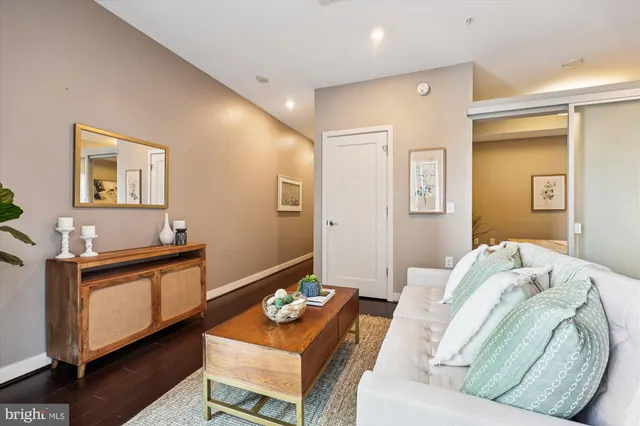 a living room with furniture and a wooden floor