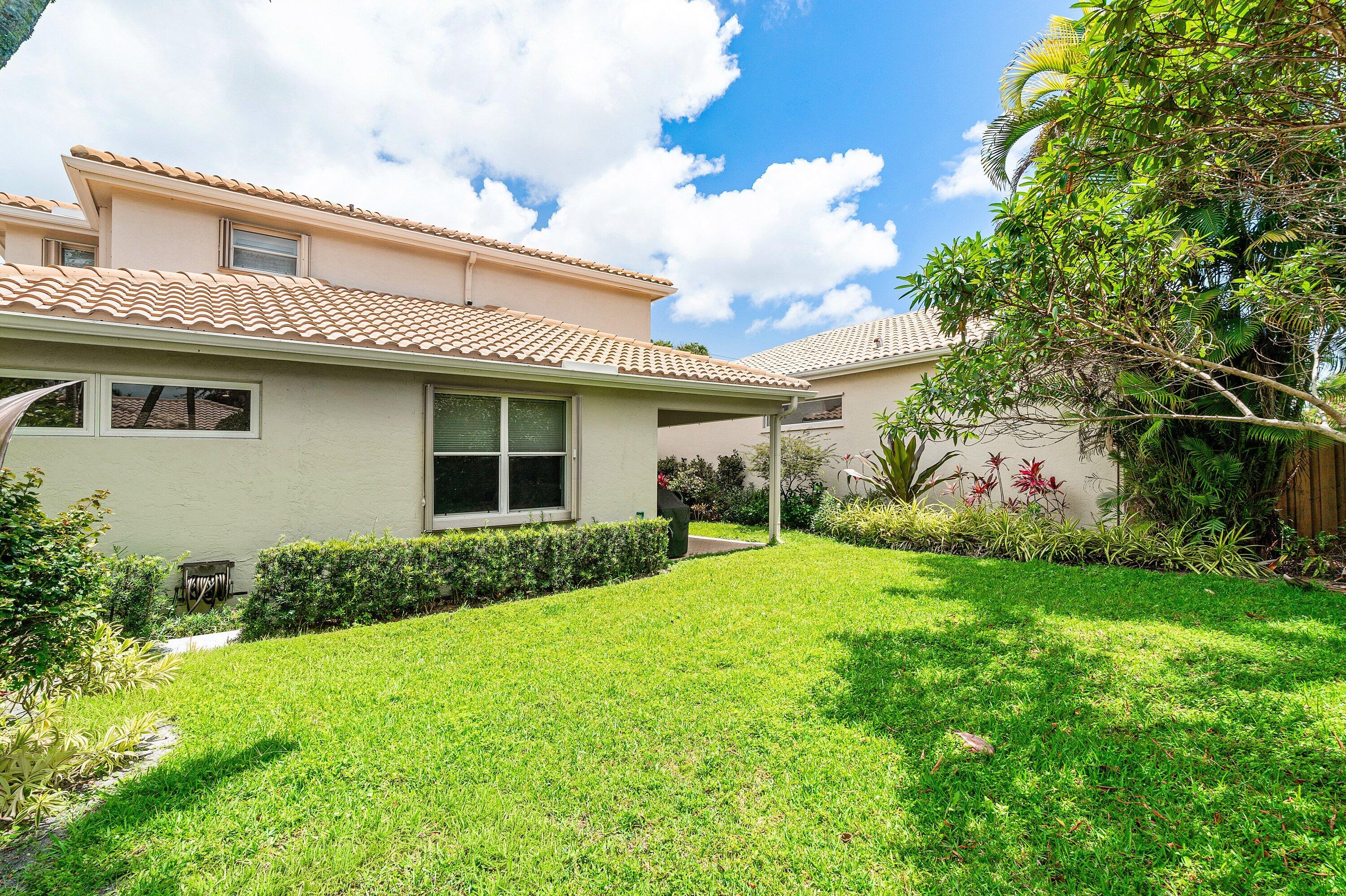 2404 Northwest 67th Street Boca Raton, FL 33496 - Photo 39 of 74 a view of a house with backyard and garden